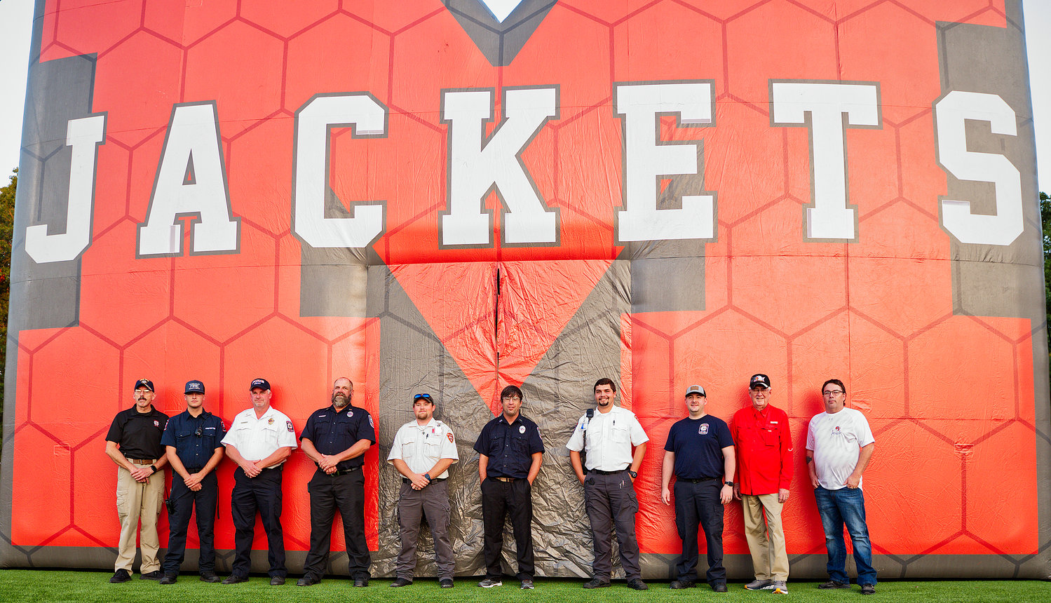 First responders gather in front of the Yellowjackets' tunnel Friday before the home game Friday.